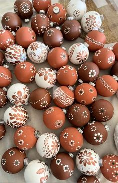 some brown and white decorated eggs on a table