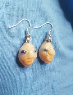 a pair of earrings that have been made to look like an animal