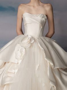 a woman in a wedding dress with flowers on it