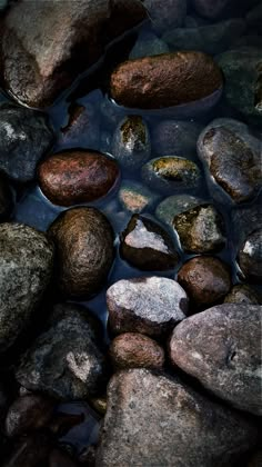 some rocks and water are in the middle of this photo with no one around them