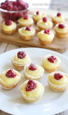 small pastries with raspberries are on a plate