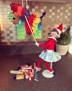 the elf is holding an umbrella next to some candy