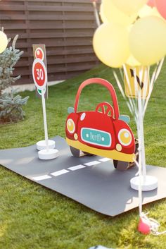 an image of a car on the road with balloons in the air and a sign that says happy birthday