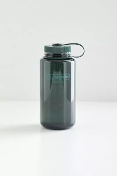 a gray water bottle sitting on top of a white table