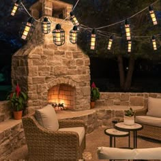 an outdoor fireplace with patio furniture and string lights strung around it, on instagram