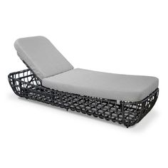 an outdoor chaise lounge chair made out of metal wire and grey fabric, on white background