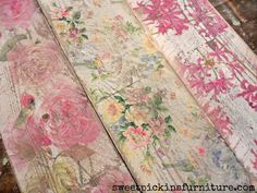 three wooden boards with flowers painted on them