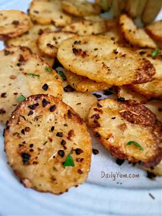 some fried potatoes on a white plate with seasoning