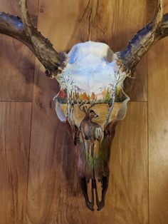 a deer's skull with antlers on a wooden floor