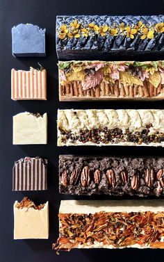 five different types of chocolate bars lined up on top of each other with flowers and leaves