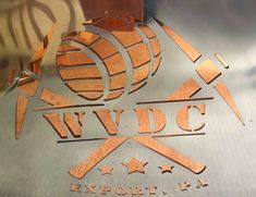 the wwdc logo is made out of wood and metal with stars on it