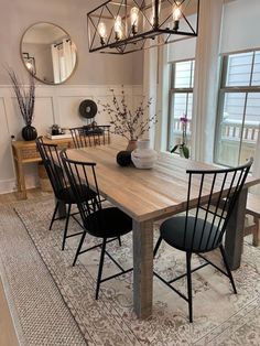 a dining room table with black chairs around it