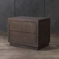 a wooden cabinet sitting on top of a tile floor next to a gray brick wall