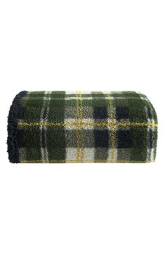 a green and yellow plaid blanket on a white background