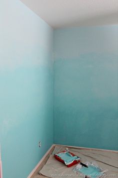 an empty room with blue walls and white paint