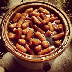 a bowl filled with lots of beans sitting on top of a counter