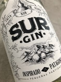 a close up of a bottle of wine on a table with a label that says sur gin