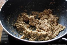 some food is cooking in a pan on the stove top and ready to be cooked