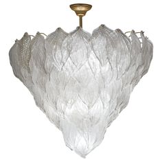 a glass chandelier hanging from a ceiling fixture