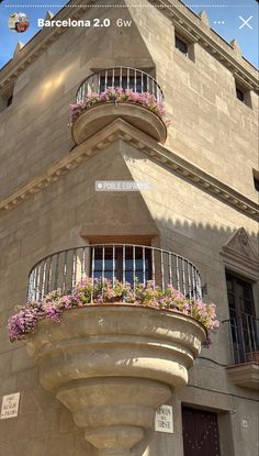 an apartment building with flowers on the balconies and balcony railings in barcelona, spain