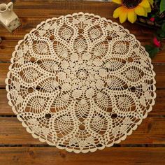 a white doily sitting on top of a wooden table