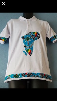 - Comfortable soft cotton polo collared shirt  - 100% African wax print Appliqué on front center and sleeves  - Classic & Fitted  Care Instructions:  Machine wash cold with mild detergent. Do not bleach. Hang to dry, Iron if needed. *Model wearing size Large*  Sizes available: Small, Medium, Large, Extra Large Casual Collared Printed T-shirt, Cotton Collared T-shirt With Graphic Print, Collared Cotton T-shirt With Graphic Print, Blue Cotton Collared Shirt, Blue Cotton Shirt With Collared Neckline, White Cotton Polo Shirt With Polo Collar, White Cotton Collared Polo Shirt, White Printed Collared T-shirt, White Collared Printed T-shirt