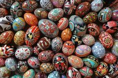 many different colored eggs are stacked on top of each other in the same pattern and shape