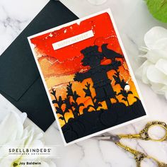 a card with an image of a scarecrow on it next to scissors and flowers