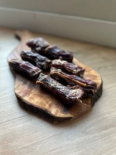 dried raisins sitting on a wooden cutting board next to a white window sill