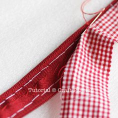 red and white checkered fabric being sewn together