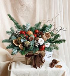 a vase filled with lots of different types of christmas decorations on top of a table