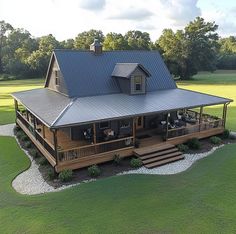 an aerial view of a house in the middle of a field