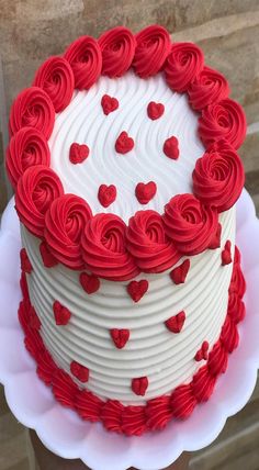 a red and white cake with hearts on it