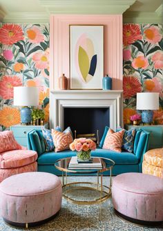 a living room filled with furniture and flowers on the wall behind a fire place in front of a fireplace