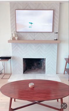 a living room with a fire place and a flat screen tv mounted above the fireplace