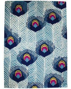 blue and white peacock print fabric with multicolored feathers