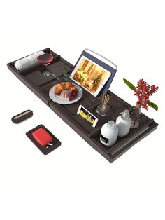 there is a tray with food on it and a laptop computer sitting on top of it