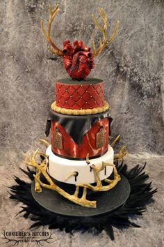 a red and black cake on top of a table