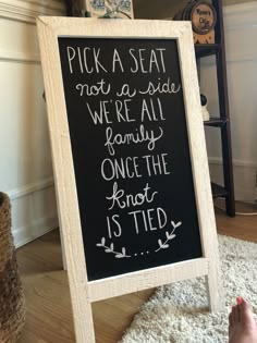 a chalkboard sign that says pick a seat not a side we're all family once the knot is tied