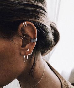 a close up of a person with ear piercings