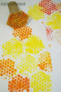 an orange, yellow and red doted paper is on the table