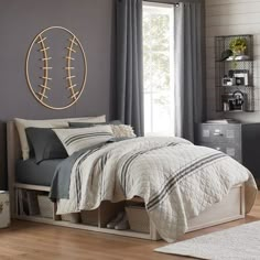 a bedroom with a bed, dresser and mirror