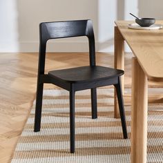 a black chair sitting on top of a wooden floor