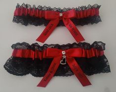 two red and black garters with ribbons on them