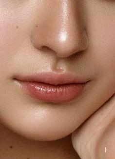 a close up shot of a woman's face with her hand on her cheek