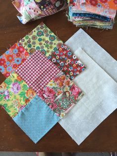 several pieces of fabric sitting on top of a wooden table