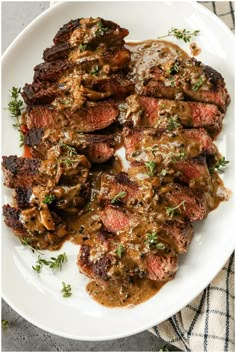 steak with mushroom gravy on a white plate