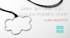 a necklace with a quote on it that says, grey sky just clouds passing over