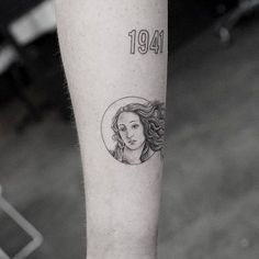 a woman's face is shown on the left side of her arm, with an inscription underneath it