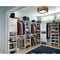 an organized closet with clothes and shoes